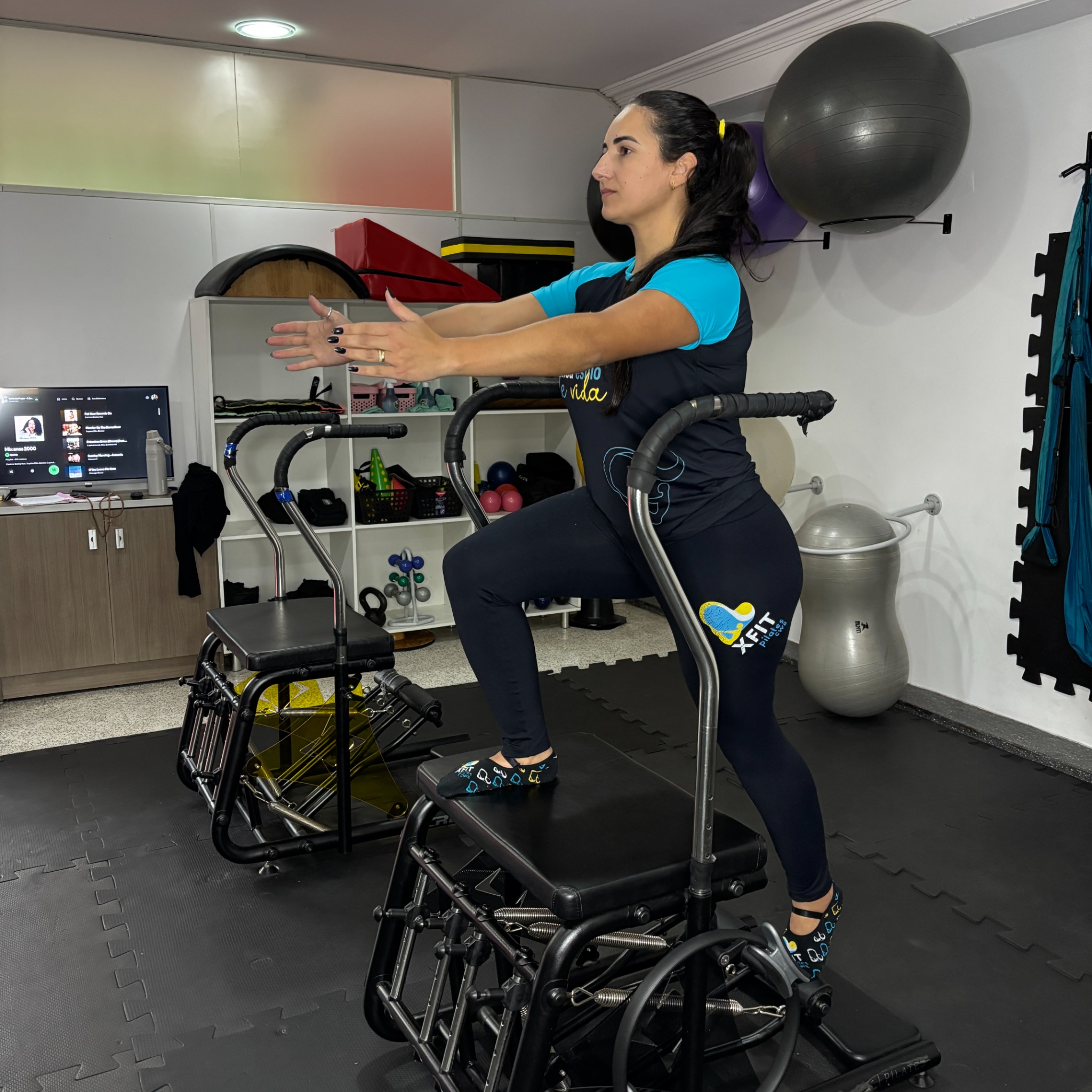 Aluna praticando exercício em aparelho na XFIT